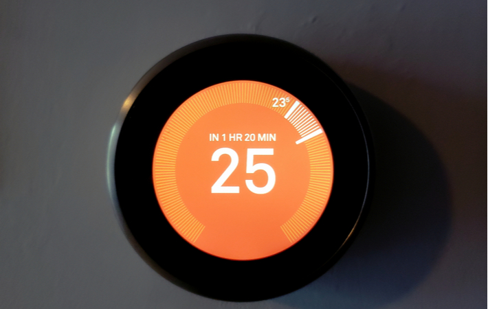 a smart home thermostat showing the temperature is 25 degrees
