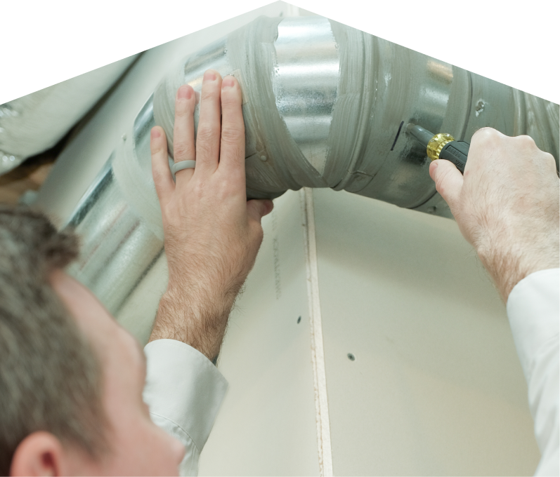 Limcan HVAC technician inspecting and tightening a joint on a sealed metal air duct, performing maintenance work during an air duct cleaning task. Limcan HVAC technician inspecting and tightening a joint on a sealed metal air duct, performing maintenance work during an air duct cleaning task.