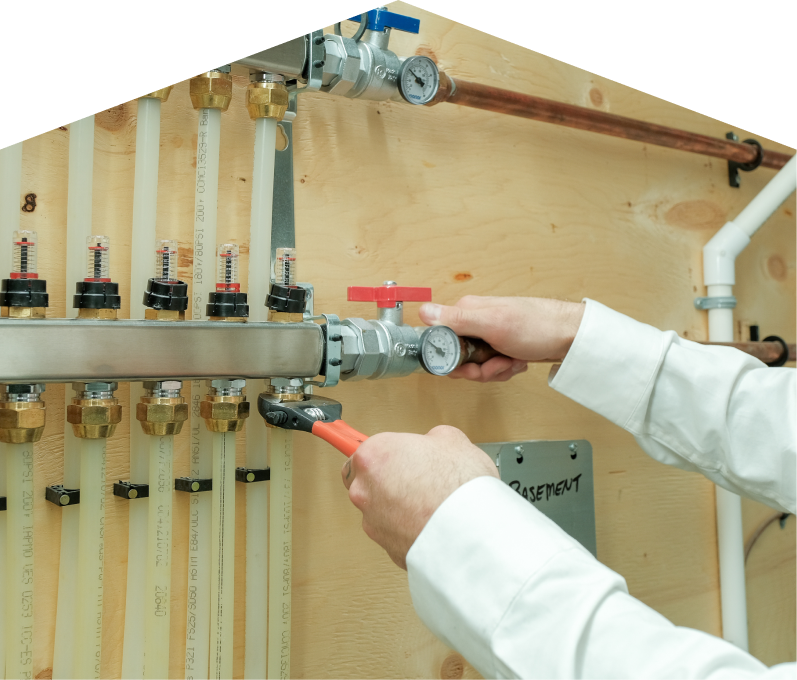 Limcan HVAC specialist performing boiler repair, adjusting internal components of a residential unit with visible copper piping and control wiring. Limcan HVAC specialist performing boiler repair, adjusting internal components of a residential unit with visible copper piping and control wiring.