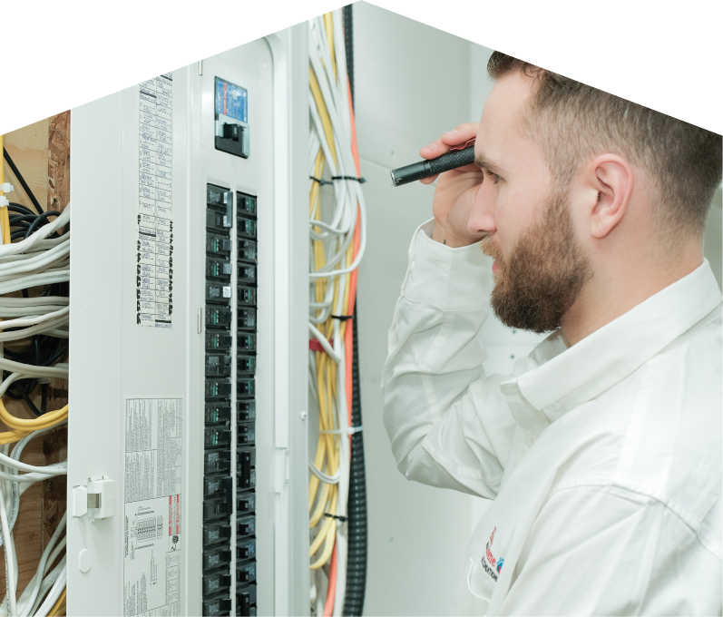 Limcan electrician inspecting residential electrical panel wiring with a flashlight, checking connections and circuit labels. Limcan electrician inspecting residential electrical panel wiring with a flashlight, checking connections and circuit labels.