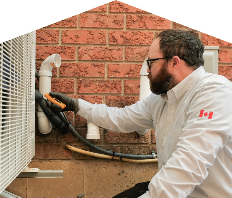 Limcan HVAC specialist checking insulated piping on a heat pump unit beside a brick wall during a diagnostic service. Limcan HVAC specialist checking insulated piping on a heat pump unit beside a brick wall during a diagnostic service.