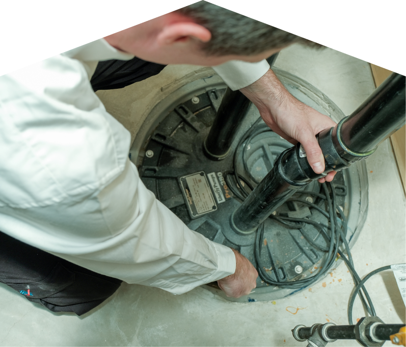 Limcan sump pump specialist secures discharge piping on a sealed basin during a sump pump installation in a basement utility area. Limcan sump pump specialist secures discharge piping on a sealed basin during a sump pump installation in a basement utility area.