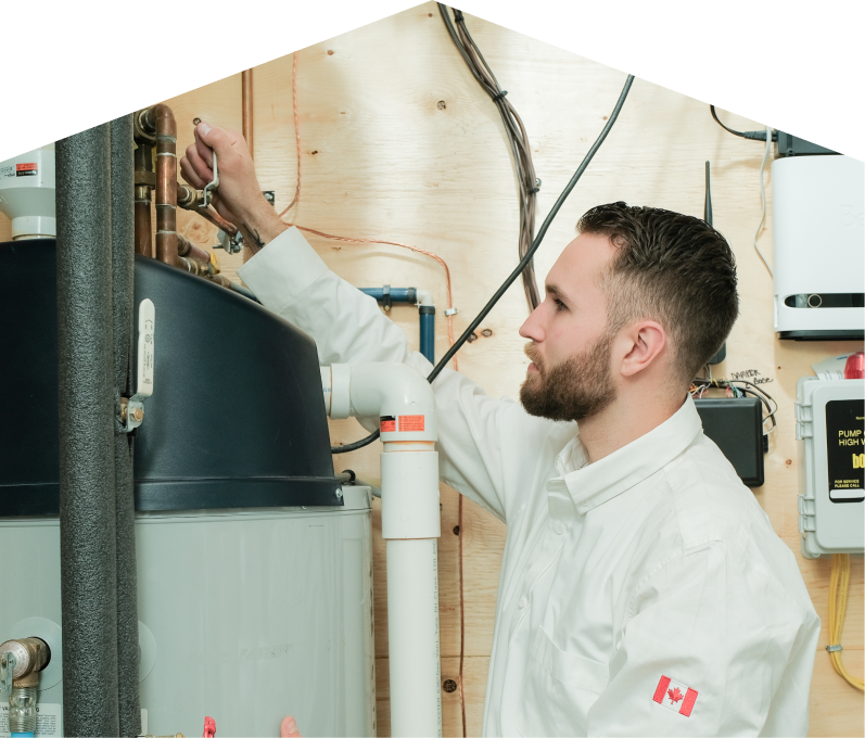 Limcan water heater specialist adjusts piping on a large residential unit during a repair service, with exposed wood paneling and mounted utility components in the background. Limcan water heater specialist adjusts piping on a large residential unit during a repair service, with exposed wood paneling and mounted utility components in the background.