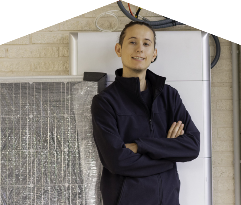 Limcan specialist standing confidently with arms crossed beside newly delivered system components, including a wrapped panel and wall-mounted utility unit. Limcan specialist standing confidently with arms crossed beside newly delivered system components, including a wrapped panel and wall-mounted utility unit.