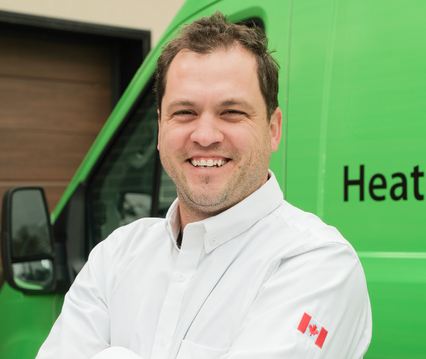 Smiling Limcan technician standing confidently in front of their green service van, wearing their white issued uniform. Smiling Limcan technician standing confidently in front of their green service van, wearing their white issued uniform.